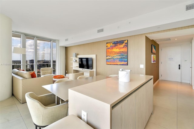 tiled living room with floor to ceiling windows