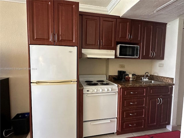 kitchen with light tile patterned floors, sink, and white appliances