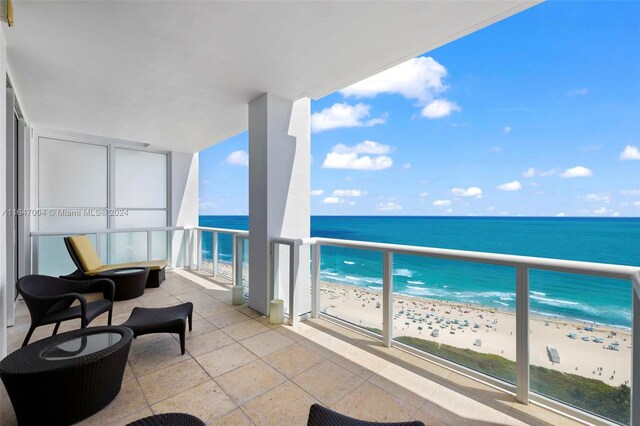 balcony with a view of the beach and a water view