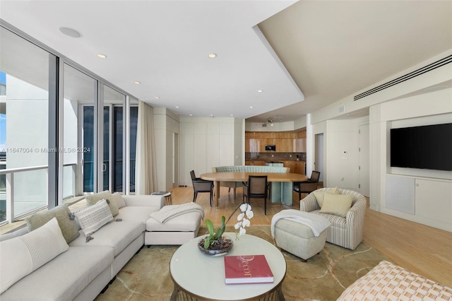 living room with plenty of natural light and light hardwood / wood-style floors