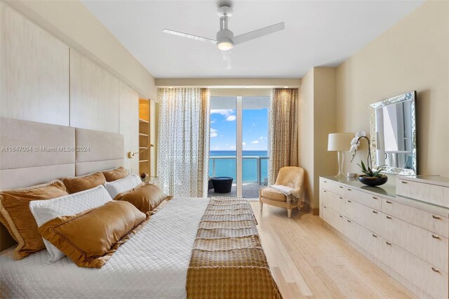 interior space with ceiling fan, a water view, and light wood-type flooring