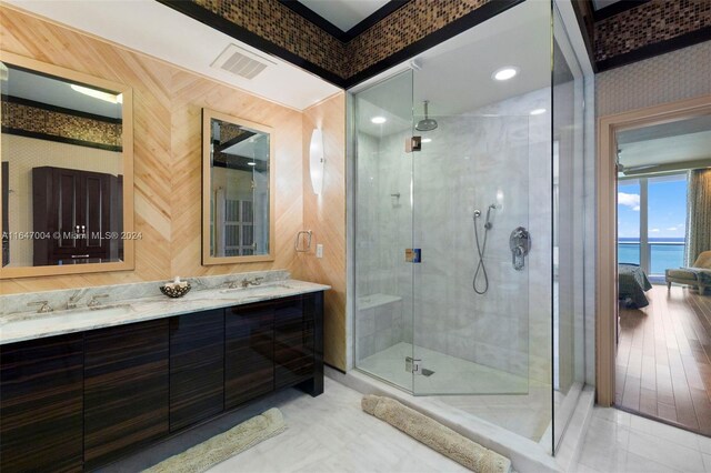 bathroom with an enclosed shower, a water view, vanity, and tile patterned floors