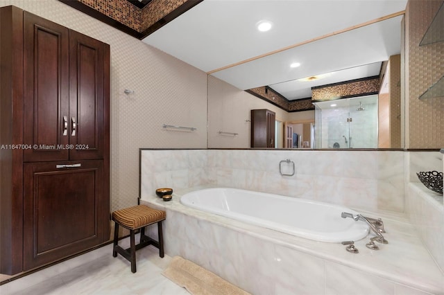 full bathroom featuring a shower stall, a bath, and wallpapered walls