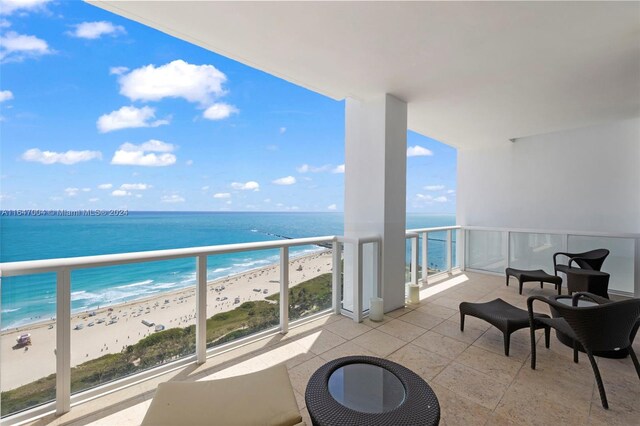 balcony with a view of the beach and a water view