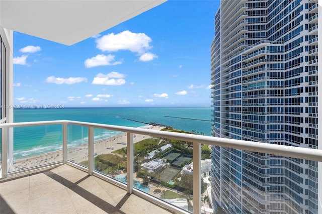 balcony with a beach view and a water view