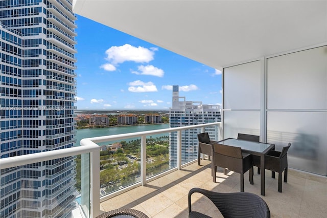 balcony featuring a view of city and a water view