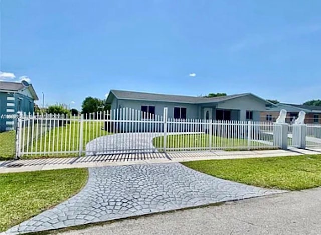 view of front of property with a fenced front yard, a front yard, and a gate