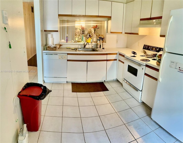 kitchen with white cabinets, white appliances, sink, and light tile patterned floors