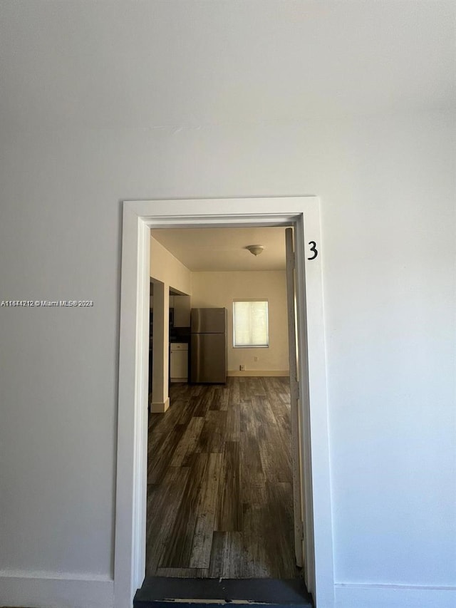 corridor featuring dark hardwood / wood-style floors