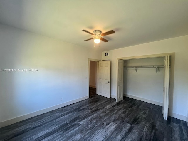 unfurnished bedroom with ceiling fan, dark hardwood / wood-style floors, and a closet