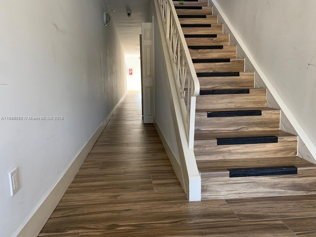 stairs with hardwood / wood-style flooring