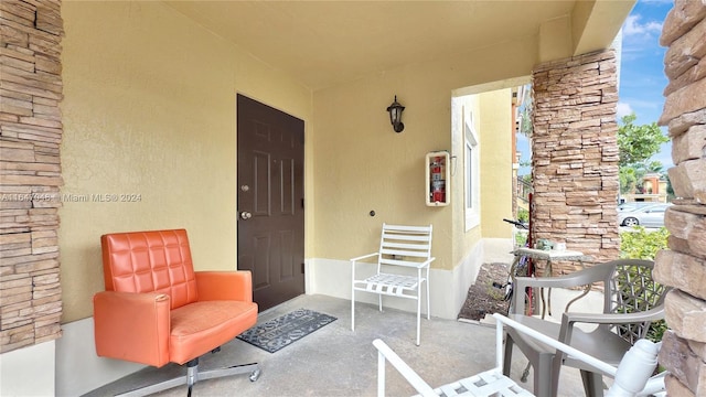 3395 NE 9th St Unit 101, Homestead, FL 33033 - doorway to property with a porch and stucco siding