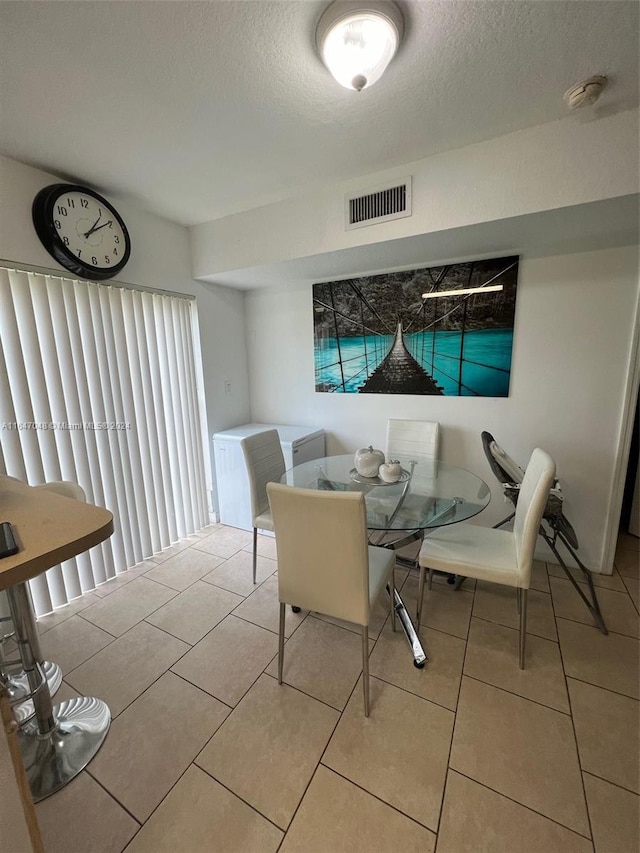 3395 NE 9th St Unit 101, Homestead, FL 33033 - dining space with a textured ceiling and tile patterned floors