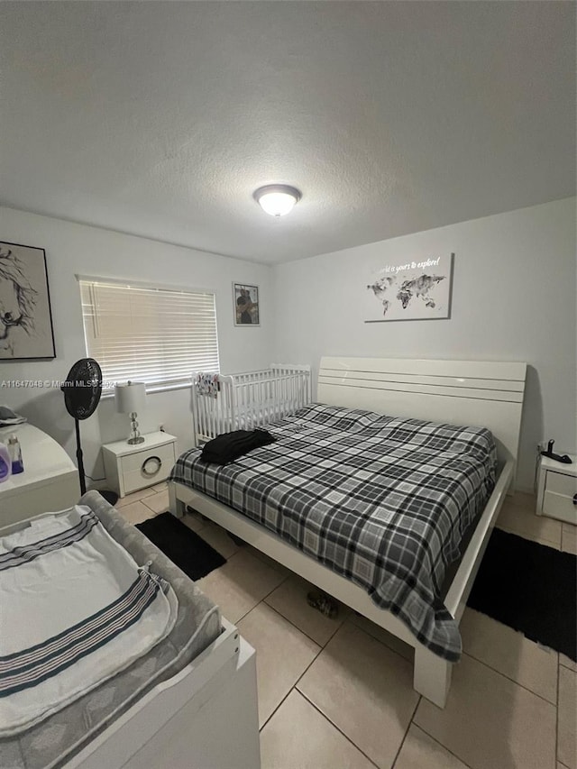 3395 NE 9th St Unit 101, Homestead, FL 33033 - tiled bedroom with a textured ceiling