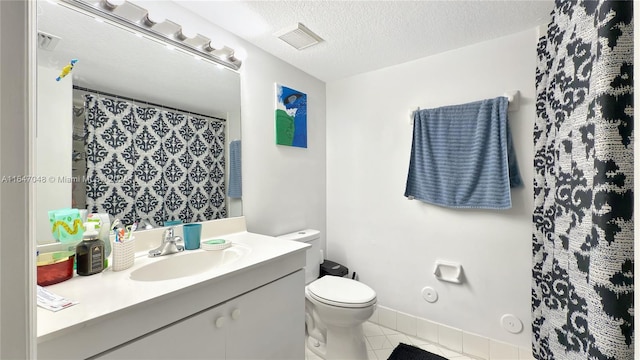 3395 NE 9th St Unit 101, Homestead, FL 33033 - bathroom featuring tile patterned flooring, toilet, vanity, a textured ceiling, and curtained shower