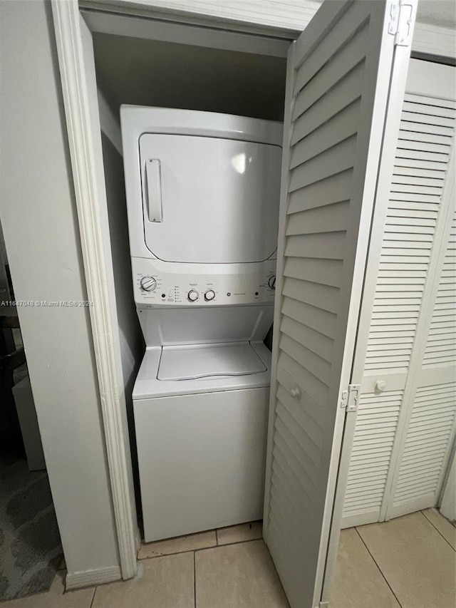 3395 NE 9th St Unit 101, Homestead, FL 33033 - clothes washing area with stacked washer / drying machine and light tile patterned floors