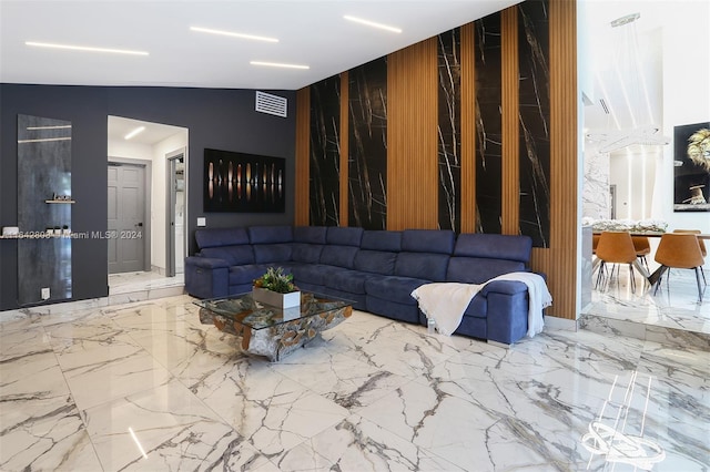 living room featuring wood walls and lofted ceiling