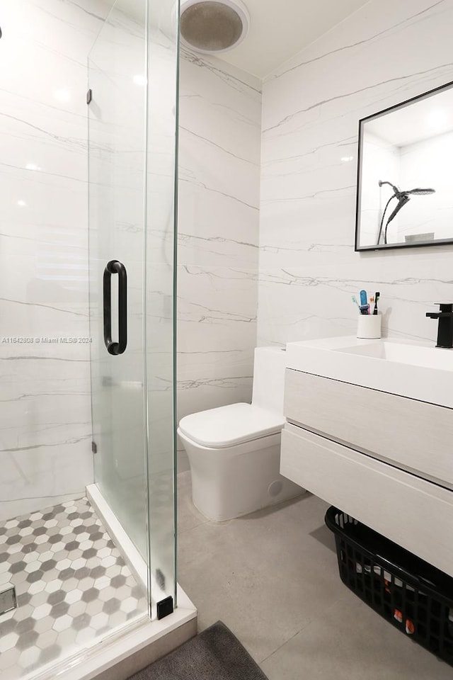 bathroom with vanity, toilet, and an enclosed shower