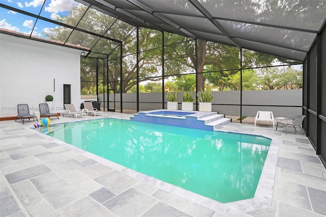 view of pool featuring a patio, an in ground hot tub, and glass enclosure