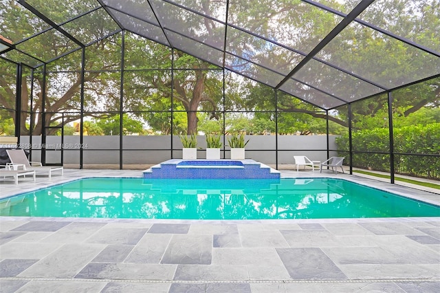 view of swimming pool with a patio, an in ground hot tub, and glass enclosure