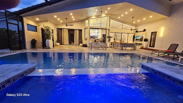 view of swimming pool with an in ground hot tub, ceiling fan, a lanai, and a patio area