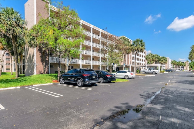 1100 NW 87th Ave Unit 308, Coral Springs, FL 33071 - view of building exterior featuring uncovered parking