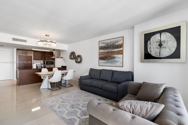 living area with visible vents and light tile patterned floors