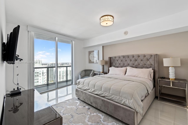 bedroom with access to outside, a wall of windows, and light tile patterned flooring