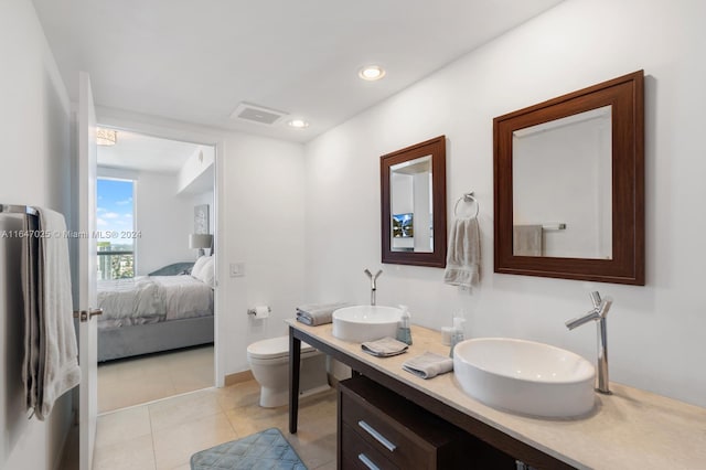 ensuite bathroom with a sink, toilet, connected bathroom, and tile patterned floors