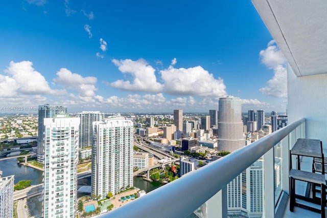 balcony with a view of city and a water view