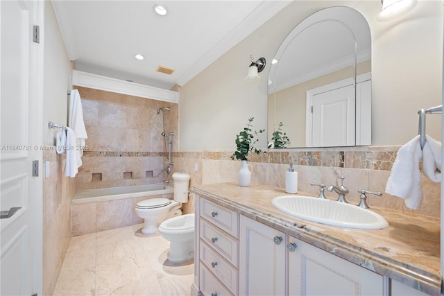 full bathroom featuring tiled shower / bath, tile walls, ornamental molding, vanity, and a bidet