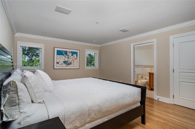 bedroom featuring crown molding, connected bathroom, and light hardwood / wood-style flooring