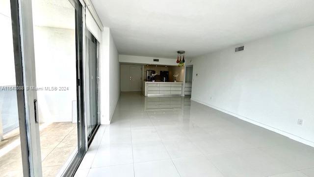 unfurnished living room with light tile patterned flooring