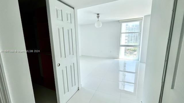 corridor with light tile patterned floors