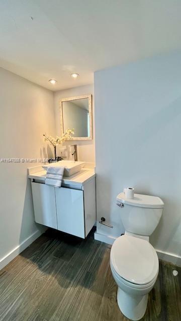 bathroom featuring hardwood / wood-style floors, toilet, and vanity