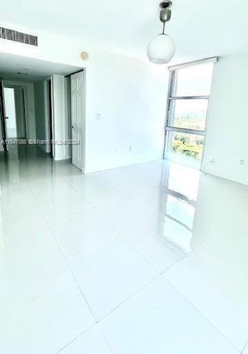 unfurnished room featuring tile patterned floors