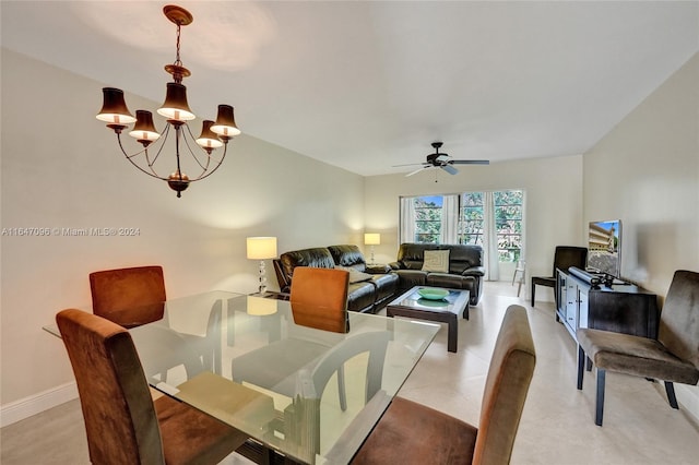 dining area featuring ceiling fan with notable chandelier