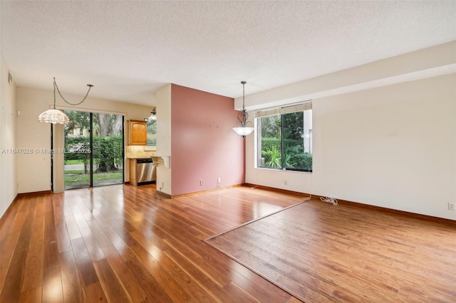 1010 NW 105th Way Unit B-139, Plantation, FL 33322 - spare room featuring a textured ceiling, light wood finished floors, and baseboards
