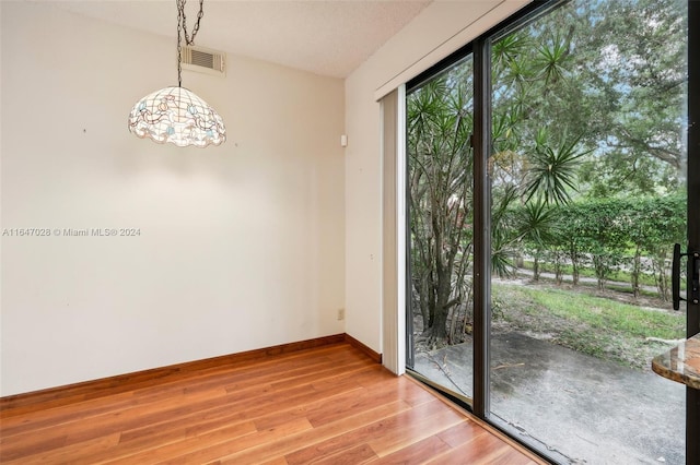 interior space with light hardwood / wood-style floors and an inviting chandelier