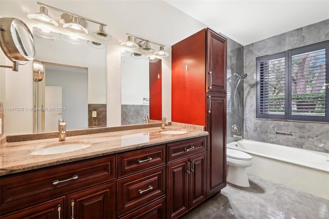 full bathroom featuring vanity, tiled shower / bath combo, tile walls, tile patterned flooring, and toilet