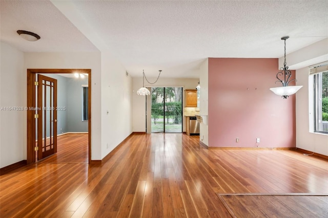 1010 NW 105th Way Unit B-139, Plantation, FL 33322 - spare room featuring light wood-style floors, plenty of natural light, and a textured ceiling