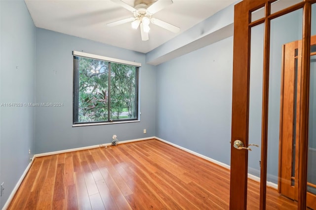 spare room featuring hardwood / wood-style flooring and ceiling fan