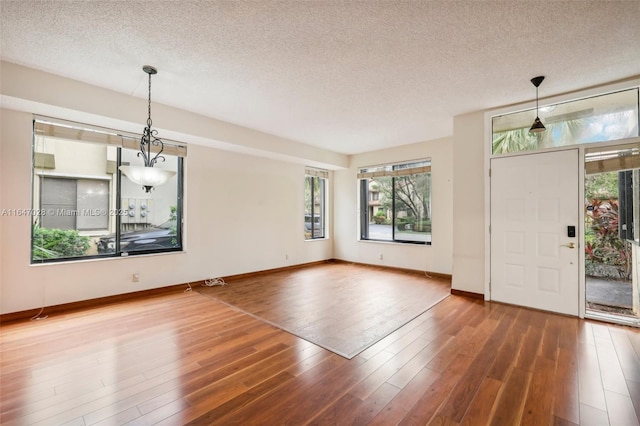 1010 NW 105th Way Unit B-139, Plantation, FL 33322 - entryway with healthy amount of natural light, a textured ceiling, wood finished floors, and baseboards