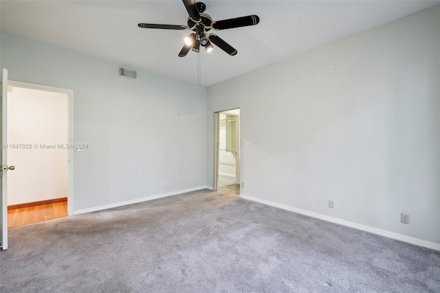 spare room featuring light carpet and ceiling fan