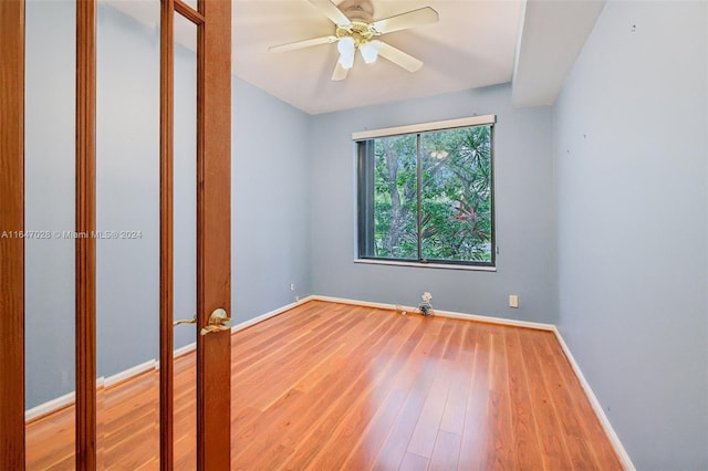 spare room with hardwood / wood-style floors and ceiling fan