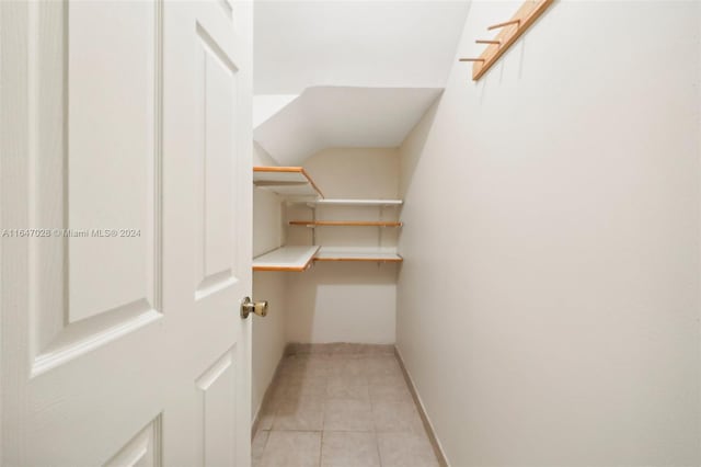 walk in closet featuring light tile patterned flooring