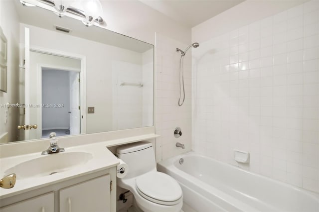 full bathroom featuring toilet, vanity, and tiled shower / bath combo