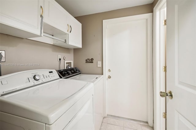 laundry room featuring light tile patterned flooring, cabinets, and independent washer and dryer