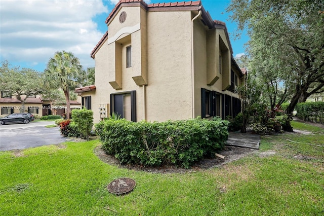 view of home's exterior featuring a yard