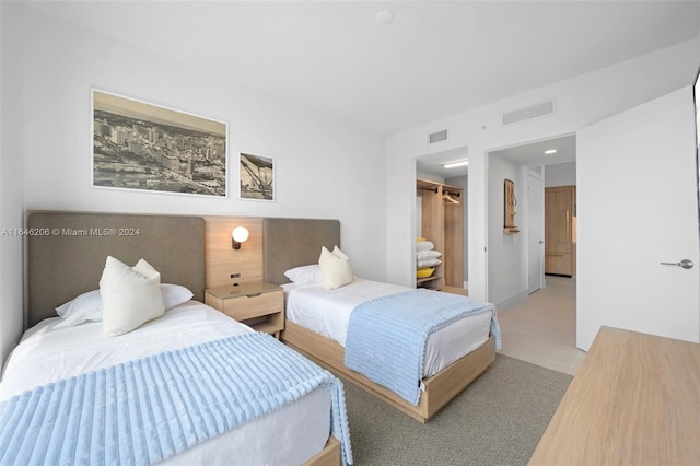 bedroom featuring a closet and light tile patterned floors